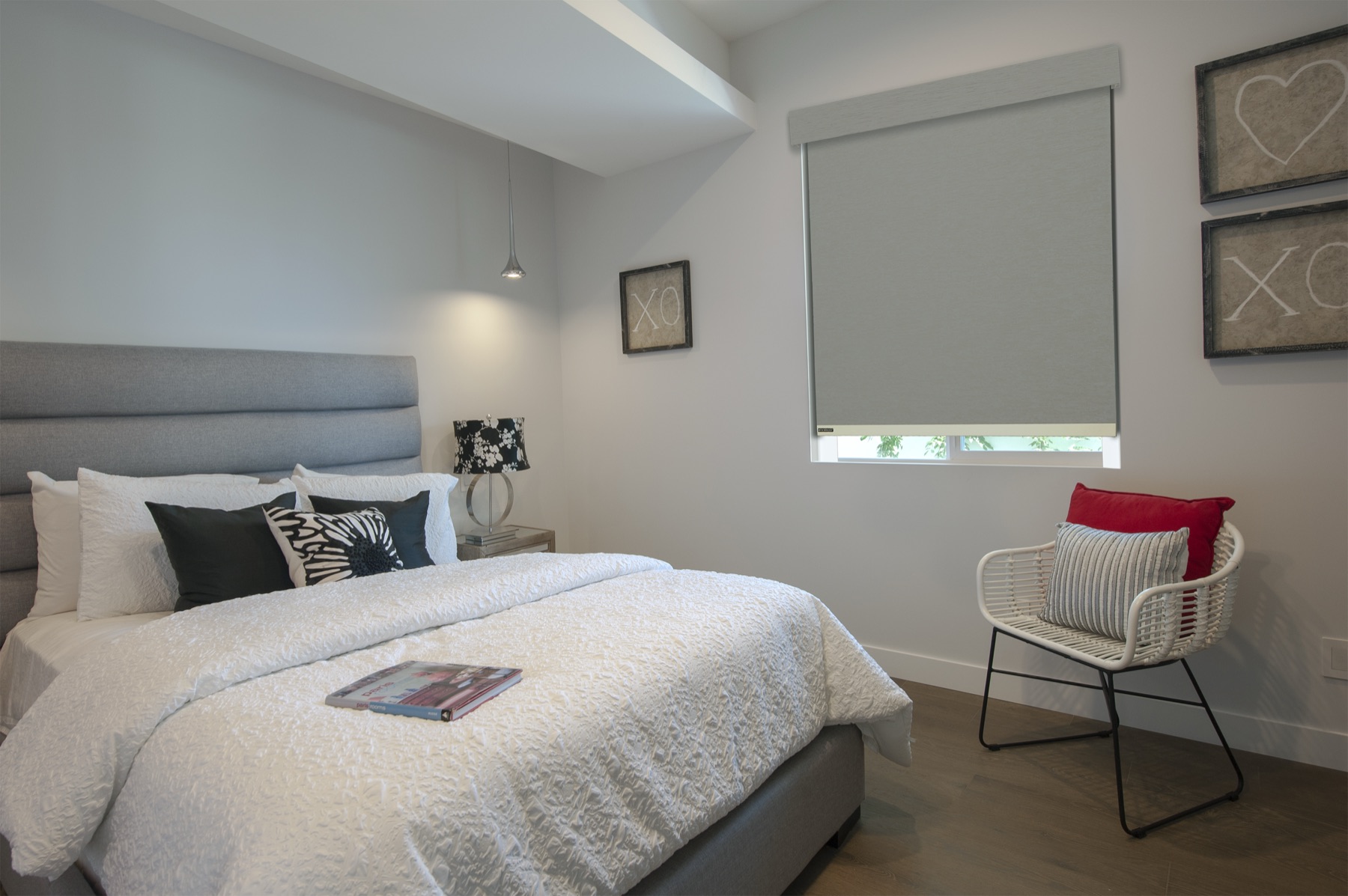 Norman LightGuard room-darkening roller shade in a bedroom